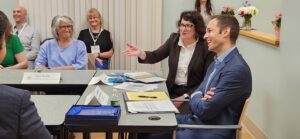 Anita Christie, Board Chair, Cynthia Sierra, CEO and Congressman Jake Auchincloss at table